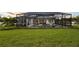 A beautiful backyard pool and spa area, with a screened-in patio and lush green lawn at 125 Hidden Estates Ct, Brandon, FL 33511