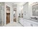 Beautiful bathroom featuring double vanity with ample storage, walk-in closet access, and walk-in shower at 125 Hidden Estates Ct, Brandon, FL 33511