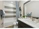 Stylish bathroom features modern fixtures, a tub with a shower, and elegant decor at 125 Hidden Estates Ct, Brandon, FL 33511