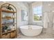 Beautiful bathroom features a luxurious soaking tub, and a bright window with natural light at 125 Hidden Estates Ct, Brandon, FL 33511