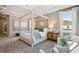 Bright main bedroom with canopy bed, natural light, and cozy sitting area creating a relaxing retreat at 125 Hidden Estates Ct, Brandon, FL 33511