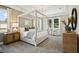 Tranquil main bedroom with a tray ceiling, canopy bed, neutral color palette and lots of natural light at 125 Hidden Estates Ct, Brandon, FL 33511