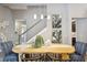 Open dining space featuring a wooden table with seating and views of the open stairwell at 125 Hidden Estates Ct, Brandon, FL 33511