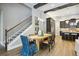 A bright dining area with wooden table, stylish seating and hardwood flooring, next to open stairwell at 125 Hidden Estates Ct, Brandon, FL 33511