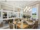 Bright dining area featuring a large table, stylish decor, modern lighting, and large windows at 125 Hidden Estates Ct, Brandon, FL 33511