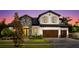 Beautiful two-story home featuring mixed stone and stucco, a three-car garage, and landscaped front yard at 125 Hidden Estates Ct, Brandon, FL 33511