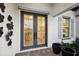Elegant double front doors with decorative glass, accented by modern planters and blue shutters at 125 Hidden Estates Ct, Brandon, FL 33511