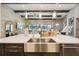 Gorgeous kitchen island with stainless steel sink and dishwasher and open view of the living area at 125 Hidden Estates Ct, Brandon, FL 33511