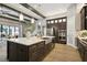 Spacious kitchen featuring a large island, modern stainless appliances, stylish cabinetry and hardwood floors at 125 Hidden Estates Ct, Brandon, FL 33511