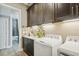 Laundry room with updated machines, counter space, and tiling at 125 Hidden Estates Ct, Brandon, FL 33511