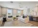 Bright living room with white sectional, accent pillows, ceiling fan, and dedicated desk area by the window at 125 Hidden Estates Ct, Brandon, FL 33511