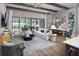 Open-concept living room boasts hardwood floors, beamed ceilings, and large sliding glass doors to the outdoor space at 125 Hidden Estates Ct, Brandon, FL 33511