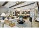 Spacious open-concept living room featuring exposed wood beams, modern furnishings, and seamless flow to the kitchen at 125 Hidden Estates Ct, Brandon, FL 33511
