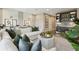 Open living area with wet bar, white sectional couch, accent pillows, and striped rug at 125 Hidden Estates Ct, Brandon, FL 33511