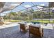 Inviting screened-in pool and spa area, surrounded by lush greenery and a spacious patio at 125 Hidden Estates Ct, Brandon, FL 33511