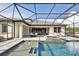 A luxurious swimming pool with a hot tub is adjacent to the outdoor dining area at 125 Hidden Estates Ct, Brandon, FL 33511
