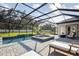 Relaxing screened-in pool area with hot tub, waterfall feature, and comfortable seating at 125 Hidden Estates Ct, Brandon, FL 33511
