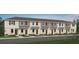 New townhouse showcases charming curb appeal with symmetrical design and neutral color palette at 14040 Textile Run, Parrish, FL 34219