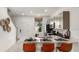 Stylish kitchen has stainless steel appliances, modern finishes, and a breakfast bar with orange stools at 14040 Textile Run, Parrish, FL 34219