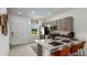 Modern kitchen features stainless steel appliances, white counters, and stylish bar stool seating at 14040 Textile Run, Parrish, FL 34219