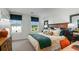 Bright main bedroom with plush bedding and ample natural light from two windows at 14040 Textile Run, Parrish, FL 34219