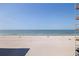 A picturesque view of the white sandy beach with clear blue ocean waters at 14048 Gulf Blvd # 302, Madeira Beach, FL 33708