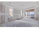 Unfinished room with drywall, windows, and sliding glass door with water view at 14048 Gulf Blvd # 302, Madeira Beach, FL 33708