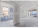 Unfinished room with drywall, windows, and sliding glass door with water view at 14048 Gulf Blvd # 302, Madeira Beach, FL 33708