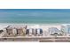 Daytime aerial view showcasing an apartment complex still under construction, situated alongside a beach near the ocean at 14048 Gulf Blvd # 201, Madeira Beach, FL 33708