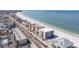 Daytime aerial view showing an apartment complex construction site by the beach and the ocean at 14048 Gulf Blvd # 201, Madeira Beach, FL 33708