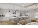 Modern kitchen featuring an island with seating, and stainless steel appliances, all open to the living area at 14048 Gulf Blvd # 201, Madeira Beach, FL 33708