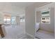 Unfinished room with sliding glass doors to a balcony with ocean views, new drywall, and an attached bathroom at 14048 Gulf Blvd # 201, Madeira Beach, FL 33708