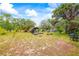Large backyard features mature trees, a pool, sheds and plenty of space for activities at 14339 Mayer Ave, Hudson, FL 34669