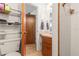 Compact bathroom with sink, toilet and shower stall. Includes tiled floors, towel rack, and shelves at 14339 Mayer Ave, Hudson, FL 34669