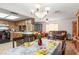 This combination dining and living room area features laminate flooring, a table, and a chandelier at 14339 Mayer Ave, Hudson, FL 34669