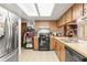 Functional kitchen features light wood cabinetry, appliances, and a skylight for natural light at 14339 Mayer Ave, Hudson, FL 34669