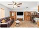 The spacious living room features a ceiling fan, wood-look floors, and large windows at 14339 Mayer Ave, Hudson, FL 34669