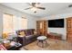 This spacious living room includes wood-look floors, leather sofas, and a large flat-screen television at 14339 Mayer Ave, Hudson, FL 34669