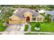 Beautiful home with lush lawn, mailbox and three-car garage near a serene lake at 1443 Obear Ct, Wesley Chapel, FL 33543