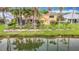 Charming two-story home with a spacious screened-in patio and lush landscaping along the canal at 1443 Obear Ct, Wesley Chapel, FL 33543