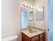 Bright bathroom features a vanity with an oval sink, a large mirror, and globe lights at 1443 Obear Ct, Wesley Chapel, FL 33543