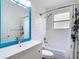 This bathroom features subway tile, a blue framed mirror, and shower-tub combination at 1443 Obear Ct, Wesley Chapel, FL 33543