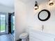 Stylish bathroom featuring a glass shower, modern vanity, and unique lighting fixtures at 1443 Obear Ct, Wesley Chapel, FL 33543