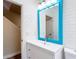 Bright bathroom featuring white subway tile, vanity with a blue framed mirror at 1443 Obear Ct, Wesley Chapel, FL 33543