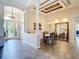 Formal dining area includes columns, a tray ceiling, and a large mirror, enhancing the architectural details at 1443 Obear Ct, Wesley Chapel, FL 33543