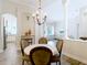 Open-concept dining room features elegant chandelier, and transitions to the living room and kitchen at 1443 Obear Ct, Wesley Chapel, FL 33543
