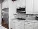 Updated kitchen features granite countertops, stainless steel microwave and appliances, and white custom cabinetry at 1443 Obear Ct, Wesley Chapel, FL 33543