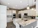 Modern kitchen boasts granite countertops, stainless steel appliances, and custom white cabinets at 1443 Obear Ct, Wesley Chapel, FL 33543