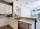 Kitchen boasts granite countertops, stainless steel appliances, breakfast bar with sink and pendant lighting at 1443 Obear Ct, Wesley Chapel, FL 33543