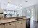 Kitchen boasts granite counters, stainless steel appliances, and breakfast bar with sink overlooking living area at 1443 Obear Ct, Wesley Chapel, FL 33543